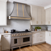 Faceted Curved Custom Stainless Steel Range Hood with Brass Straps