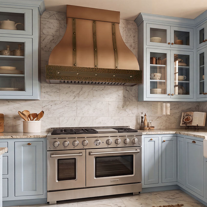 Bell-Shaped Custom Copper Range Hood with Straps and Hammered Apron