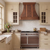 Faceted Curved Custom Copper Range Hood with Vertical Straps and Contrasting Trim