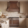 Faceted Curved Custom Copper Range Hood with Riveted Panels and Apron
