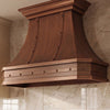 Faceted Curved Custom Copper Range Hood with Riveted Panels and Apron